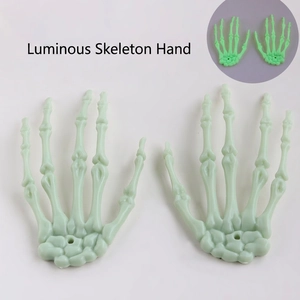 Pair of fluorescent green skeleton hand decorations for Halloween with glowing effect