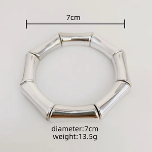 Silver bamboo style bangle bracelet with 7cm diameter and 13.5g weight on white background