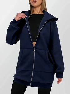 Detail of navy blue hoodie featuring a smooth metal zipper and large front pocket pockets