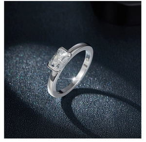Macro shot of 5x7mm radiant cut moissanite set in a polished silver ring band
