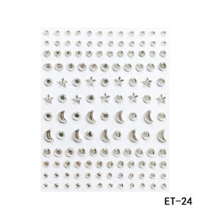 Macro detail of silver acrylic rhinestone stickers in circle star and moon shapes