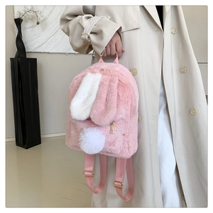 Detail showing the fluffy pink plush fabric and long bunny ears of the cute backpack