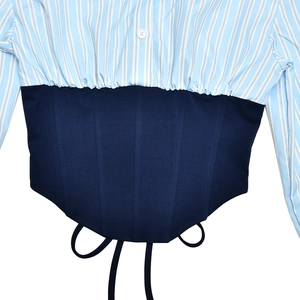 Detailed view of striped shirt patchwork with dark blue corset lace-up waist design