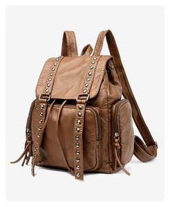 Detail of vintage brown studded backpack with drawstring closure and soft PU leather texture