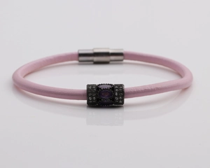 Close-up of pink leather bracelet with magnetic clasp and purple gemstone bead
