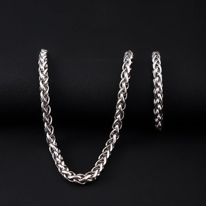 Vista macro della collana e bracciale in acciaio inossidabile argento su sfondo scuro