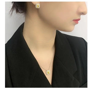 Close-up of S925 silver necklace and earrings set featuring yellow rectangular gemstones