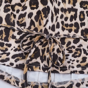 Detail of leopard print corset top featuring fabric texture and lace-up drawstring design