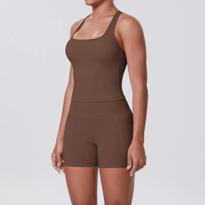 Detail of dark brown racerback yoga top and high-waisted shorts with side pockets