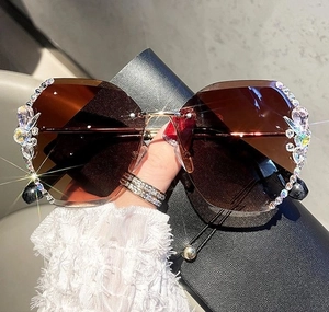 Macro shot of rimless brown gradient lenses with luxury crystal and rhinestone detailing