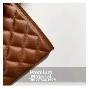 Close-up of brown quilted leather texture with premium diamond stitching on a handbag
