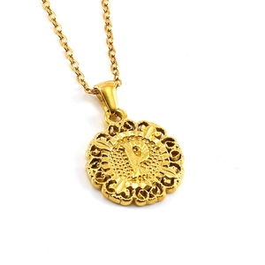 Detailed view of the 18k gold plated sunburst pendant with embossed letter P and O-chain