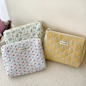 Quilted cotton cosmetic bags in floral and checkered patterns by the jolly house