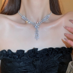 Detail view of wheat ear tassel necklace with zircon stones on female neck