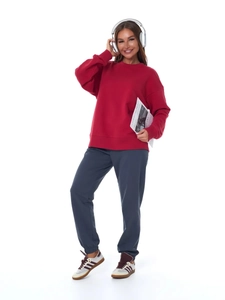 Women's burgundy crewneck sweatshirt and dark grey joggers outfit on white background