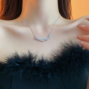 Detailed view of silver necklace featuring marquise and pear cut cubic zirconia leaf pendant
