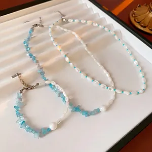 French style aquamarine and pearl beaded necklaces displayed on a white tray