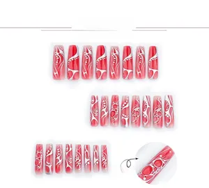 Detail of red gradient coffin nails featuring 3D silver relief and abstract art patterns