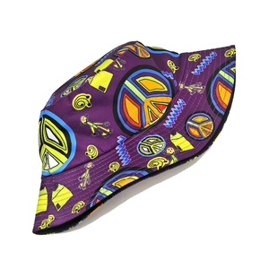 Detailed pattern view of a purple bucket hat featuring vibrant peace signs and cartoon art