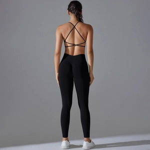 Close-up of black seamless yoga set featuring a criss-cross back sports bra and high-waist leggings