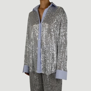 Women's silver sequin blazer and wide-leg pants set with blue striped cuffs and collar