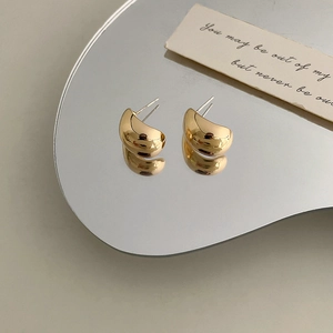 Elegant gold C-shaped ball stud earrings in polished metal finish for women