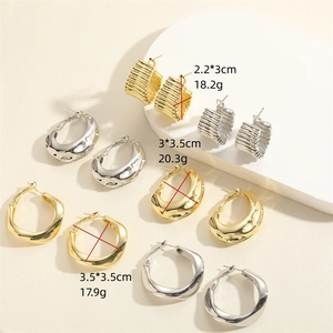 Textured gold and silver C-shape earrings in small, medium, and large sizes