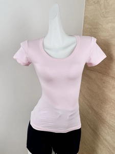 Close-up of pink slim-fit U-neck t-shirt fabric and seam detail on a white mannequin