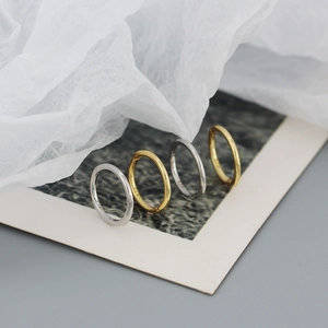 Macro detail of seamless gold and silver S925 sterling silver hoop earrings with hallmark