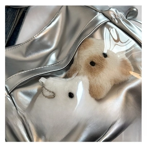 Detailed view of silver PU leather bag with transparent PVC window and plush charms