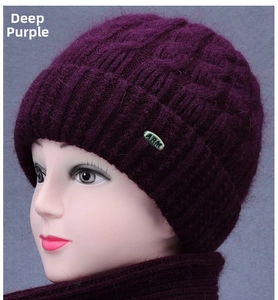 Detail of dark purple knitted hat and scarf set featuring cable stitch and ARM metal tag