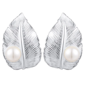 Macro detail of leaf-shaped silver stud earrings with round white pearls on a white background
