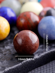 Detailed macro shot of 16mm natural crystal ball with smooth brown red stone texture
