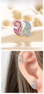 Detail of wavy ear cuff featuring pink, blue, and white pavé-set zircon crystals