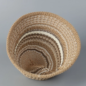 Detailed view of hand-knitted hollow striped bucket hat with brown and beige crochet texture