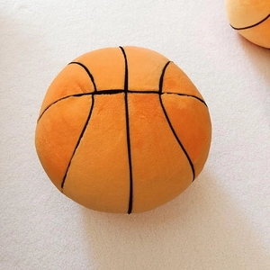 Close-up of soft plush basketball pillow with orange fabric and black stitch texture
