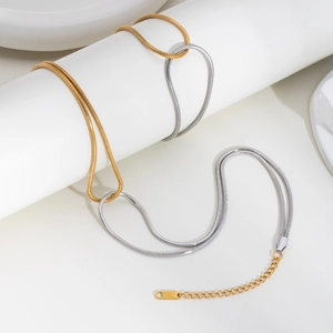 Close-up of gold and silver snake chain necklace with lobster clasp and extension