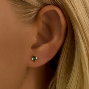 Close-up of S925 silver emerald green marquise stud earring on ear with gold plating