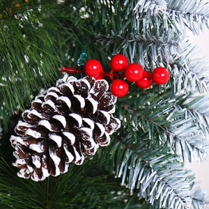 Christmas pine needle garland with snowy pinecones and glossy red berries decoration