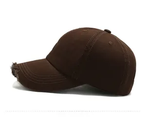 Detailed side view of dark brown distressed baseball cap with white DAY embroidery