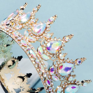 Macro detail of Baroque gold bridal crown featuring colorful AB rhinestones and filigree