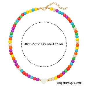 Detailed view of colorful beaded necklace with white heart pendant and weight specifications