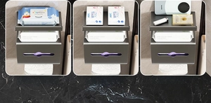 Detail view of wall-mounted metal toilet paper holder with top shelf for wet wipes and phone