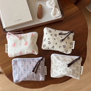Floral cotton mini storage bags in four patterns on a wooden table with zipper closure