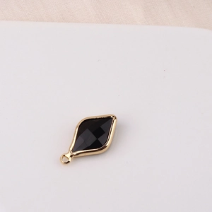 Detail of rhombic black crystal pendant with gold plating for DIY jewelry making