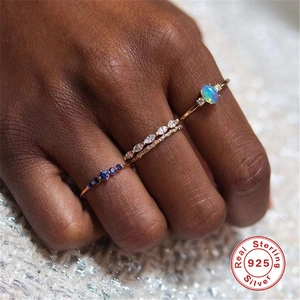 Detail of 925 sterling silver ring set featuring opal and blue zircon for stacking