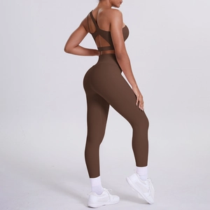 Detail of one-shoulder brown yoga set featuring high-waisted leggings and cutout sports bra