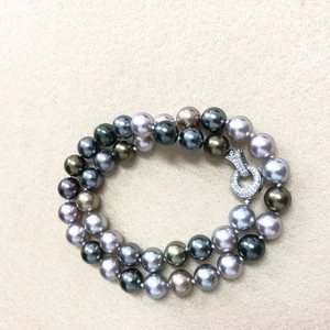 Macro shot of double-strand Tahitian style pearls with a diamond-encrusted round clasp