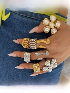 Detailed view of 8pcs mixed gold and silver rings with floral and pearl designs