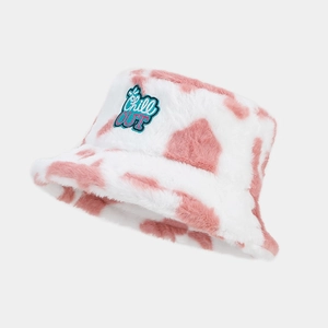 Detail of pink cow print plush bucket hat with Chill OUT embroidery and soft faux fur texture